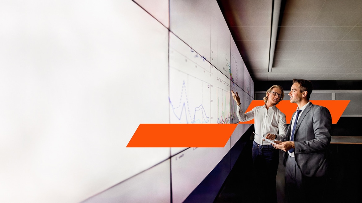 Two people looking at a wall